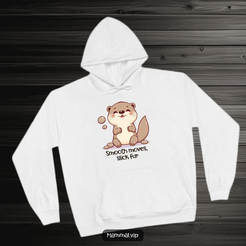 Funny hoodie depicting a cheerful otter character in the act of juggling smooth, round pebbles with great concentration.