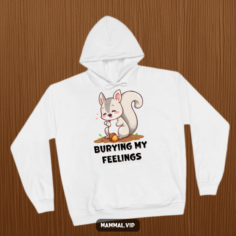 Funny squirrel hoodie showing a chattering character diligently burying an acorn, offering warmth and humor for winter.