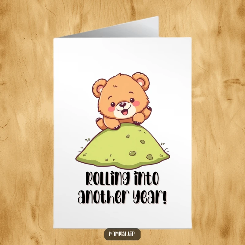 Funny Free Printable Bear Cub Birthday Card: A clumsy cub tumbles joyfully down a grassy hill, ready for celebration.